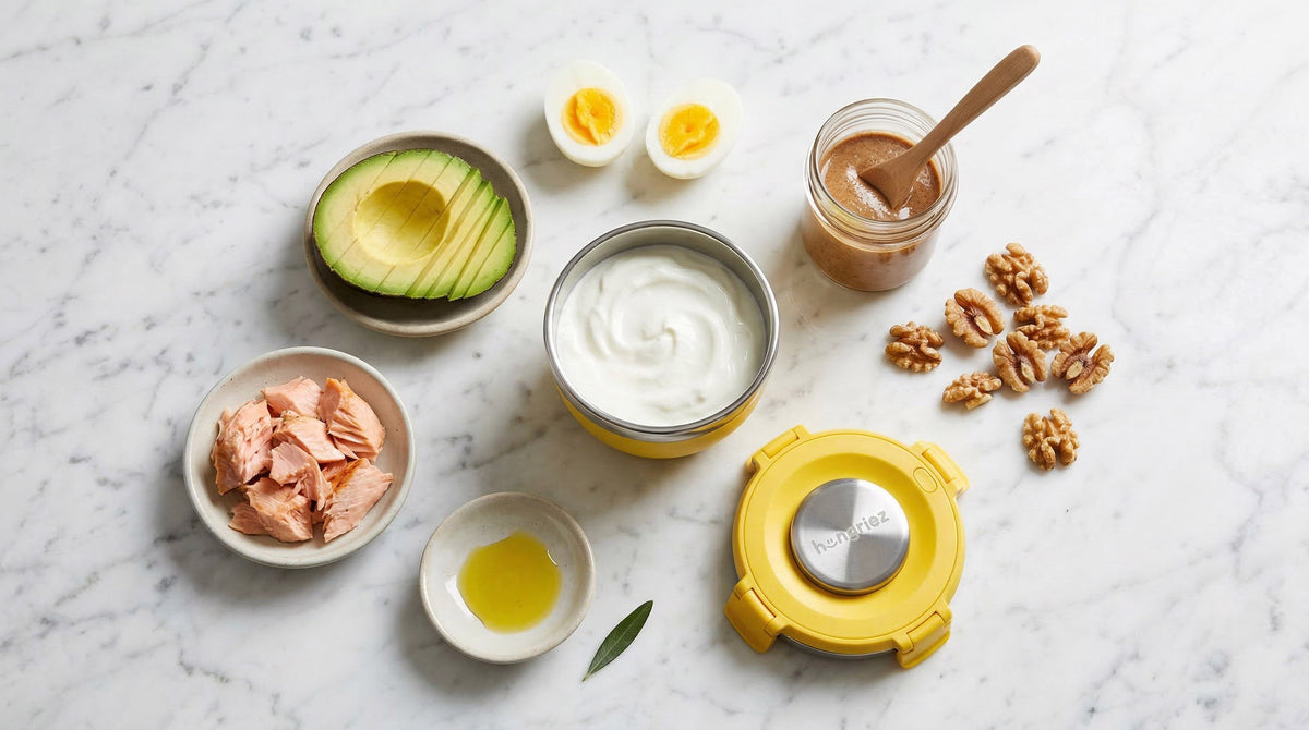 healthy fats for kids - avocado eggs salmon nuts and full fat yogurt flat lay