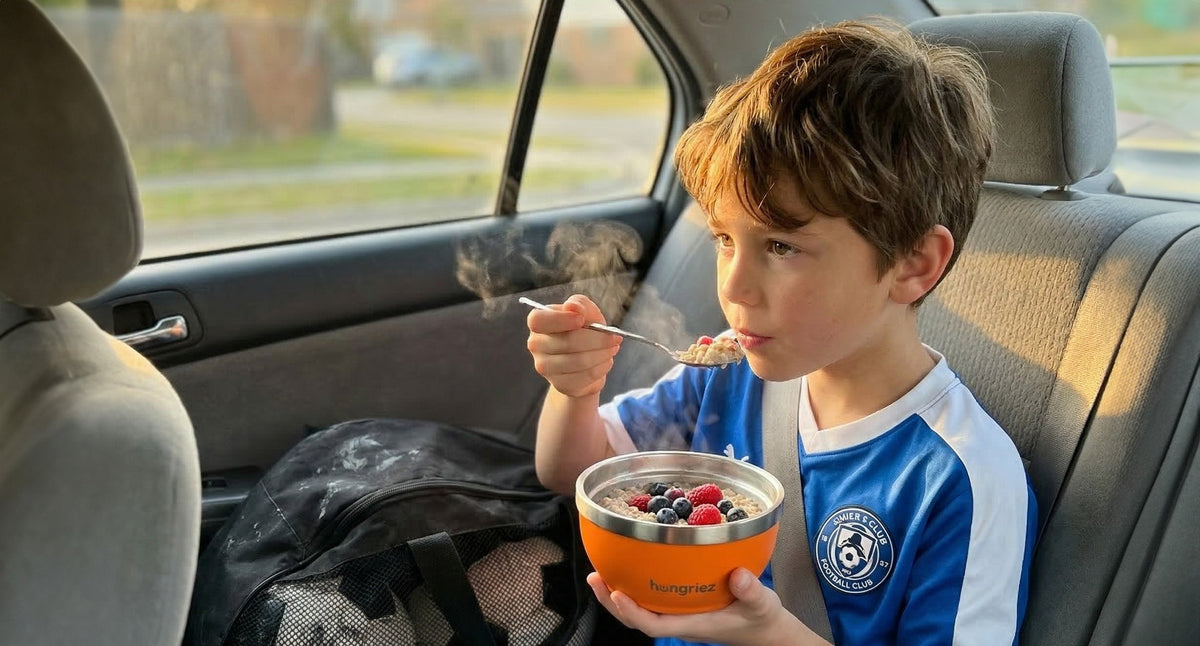 best after school snacks for kids - boy in soccer kit eating oatmeal from orange hungriez bowl in car
