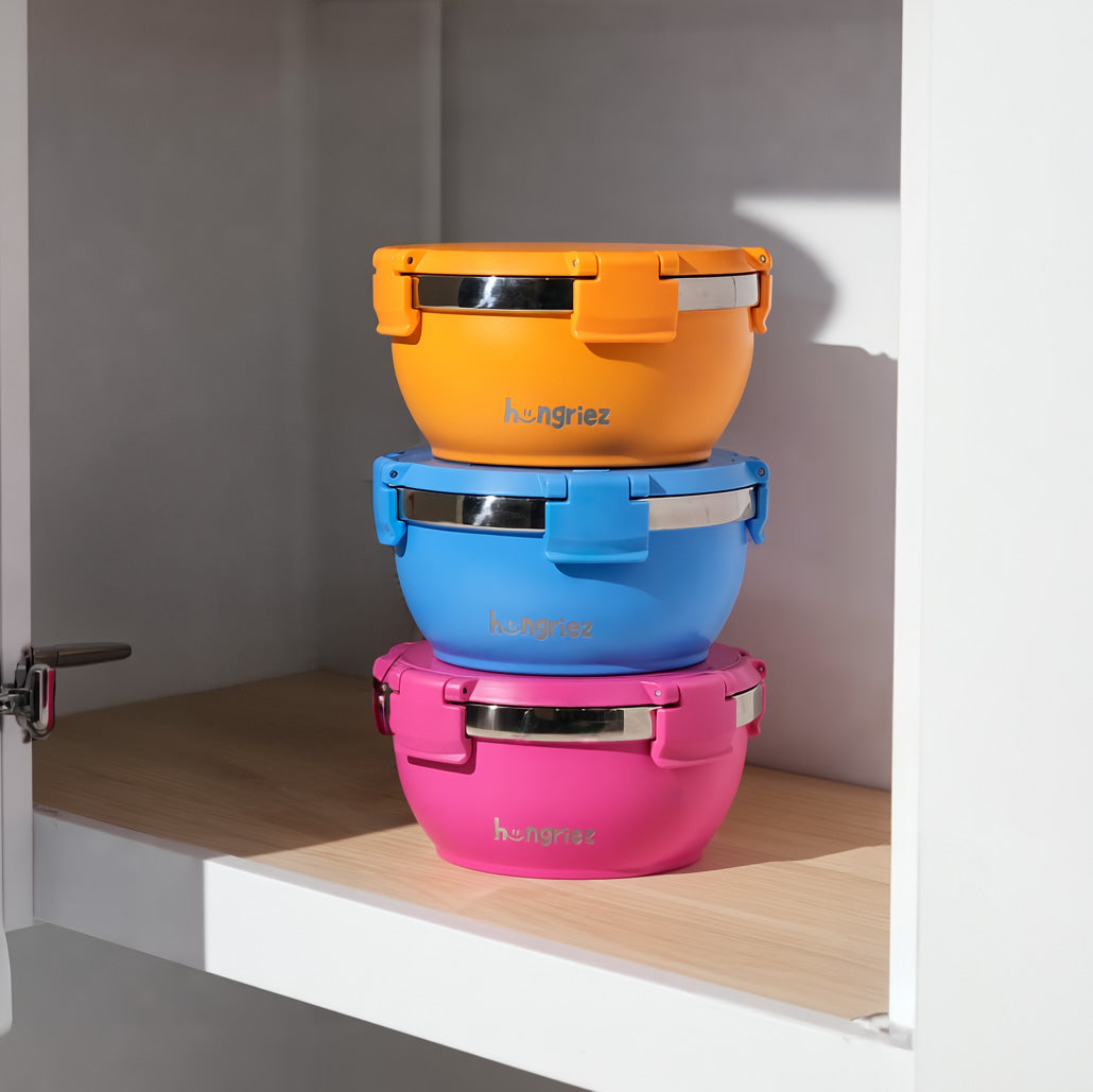 Three colours of hungriez containers on a kitchen shelf 